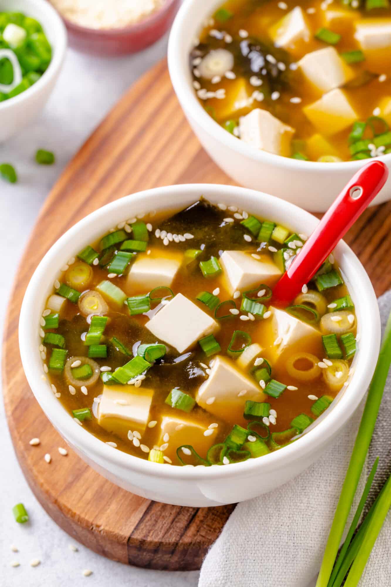 How To Make Miso Soup At Home Serving miso soup in a bowl with sesame seeds for garnish.