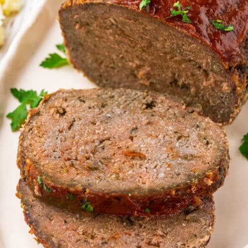Slices of meatloaf on a plate ready to eat.