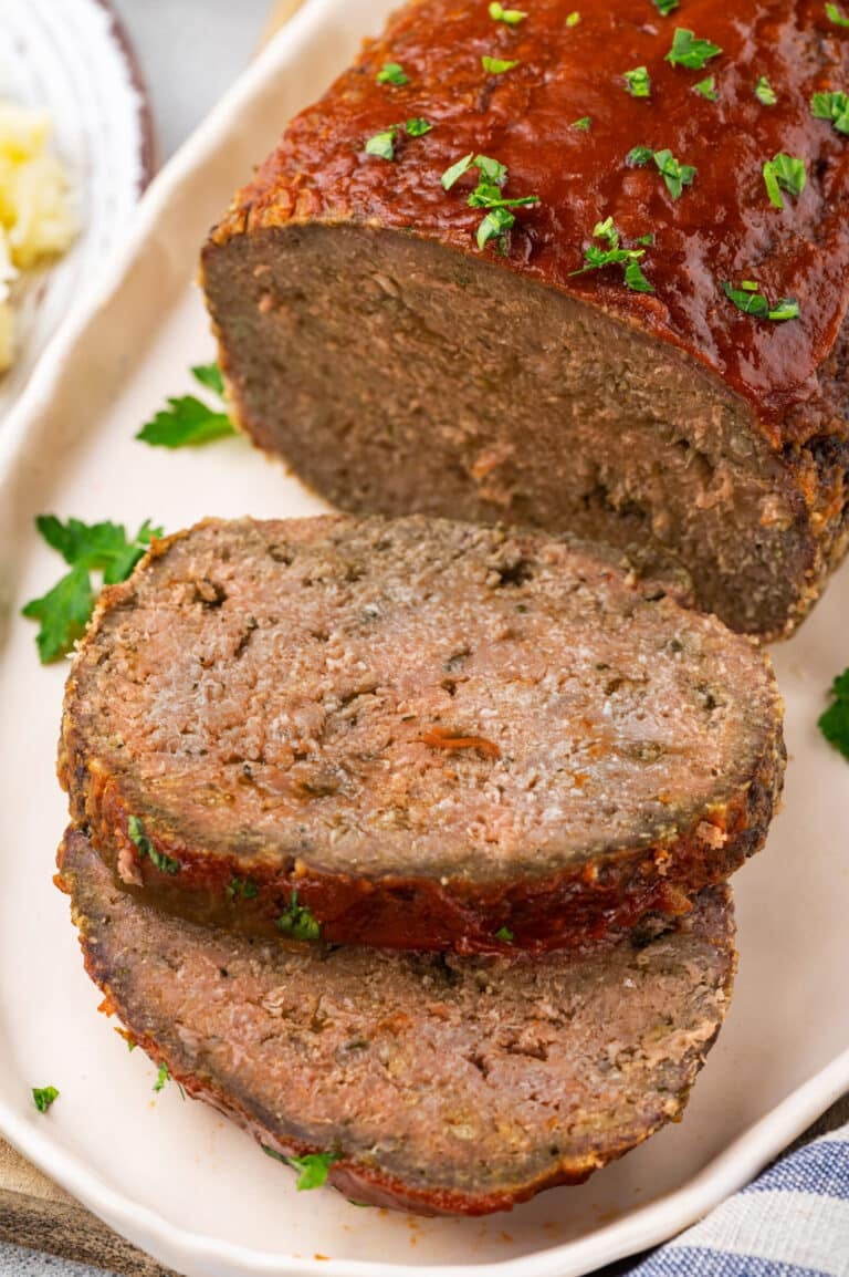 Slices of meatloaf on a plate ready to eat.