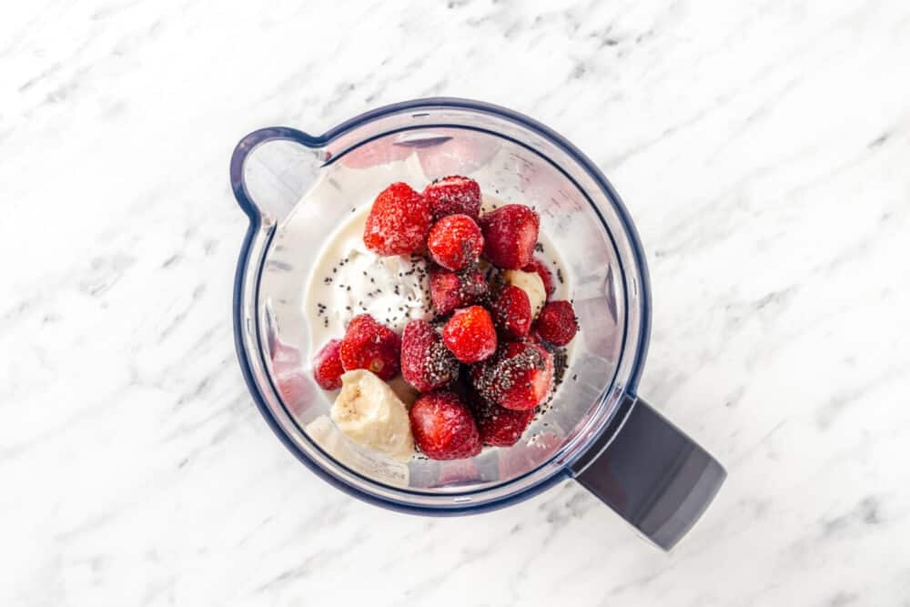Smoothie ingredients in a blender dish.